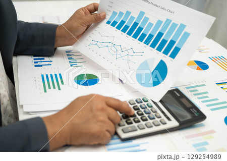 Asian business woman working with financial graph. Asian business woman working with financial graph. 129254989