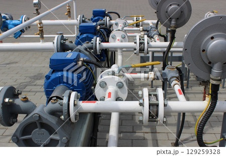 Equipment and pipe work for pumping gas at a car gas station Equipment and pipe work for pumping gas at a car gas station 129259328