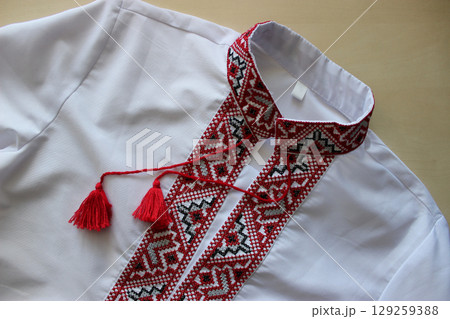 National clothing of Ukraine. Traditional ethnic dress white vyshyvanka with embroidery patterns red and black threads 129259388