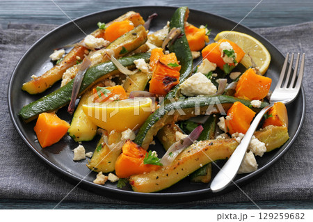 roasted vegetable salad with goat cheese on plate 129259682