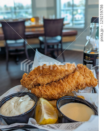 Traditional plate of fish and chips at restaurant 129259786