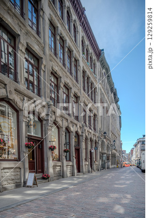 Montreal, Canada - June 05, 2025: skyline and streets of Old Montreal (Vieux) on a sunny day. 129259814