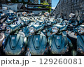 scooters on city street available for rent and ride 129260081