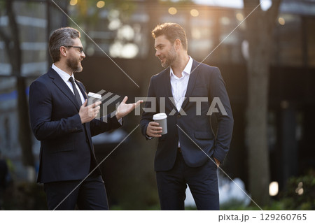 Businessman outdoor. Business man at coffee break. Businessman with coffee cup outdoor, copy space. Successful man after business meeting. Business of businessman. Coffee break 129260765