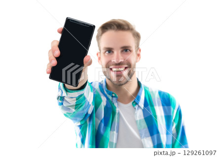 man showing phone screen on background, selective focus. photo of man presenting phone screen. man showing phone screen on background, selective focus. photo of man presenting phone screen. 129261097
