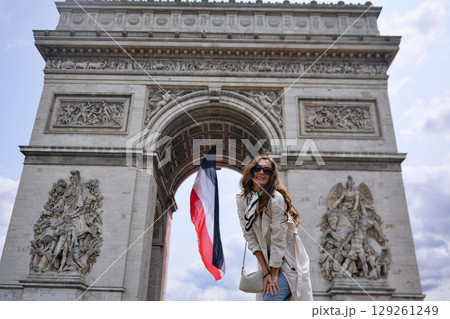 Woman with French flag at Arc de Triomphe  129261249