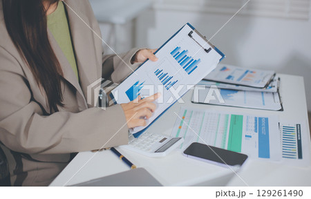 Portrait of young Hispanic professional business woman standing in office. Happy female company executive, smiling businesswoman entrepreneur corporate leader manager looking at camera using tablet Portrait of young Hispanic professional business woman standing in office. Happy female company executive, smiling businesswoman entrepreneur corporate leader manager looking at camera using tablet 129261490