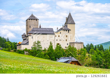 Mauterndorf Castle stands majestically against a backdrop of lush greenery and rolling hills. 129261681