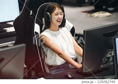 eスポーツの大会でゲームを楽しむ若い女性 129262748
