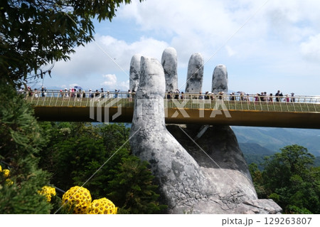 Da Nang, Vietnam Golden Bridge stone hand bridge and mountain view observatory at the Ba Na Hills Sunworld in DaNang Vietnam Da Nang, Vietnam Golden Bridge stone hand bridge and mountain view observatory at the Ba Na Hills Sunworld in DaNang Vietnam 129263807