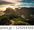 Golden Sunset Over Rio De Janeiro From Two Brothers Mountain: Dramatic Sunbeams Streaming Through Coastal Peaks Above The Atlantic Ocean And Leblon Beach 129264308