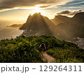 Golden Sunset Over Rio De Janeiro From Two Brothers Mountain: Dramatic Sunbeams Streaming Through Coastal Peaks Above The Atlantic Ocean And Leblon Beach 129264311
