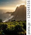 Golden Sunset Over Rio De Janeiro From Two Brothers Mountain: Dramatic Sunbeams Streaming Through Coastal Peaks Above The Atlantic Ocean And Leblon Beach 129264316