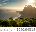 Golden Sunset Over Rio De Janeiro From Two Brothers Mountain: Dramatic Sunbeams Streaming Through Coastal Peaks Above The Atlantic Ocean And Leblon Beach 129264318