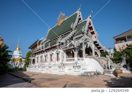 Beautiful Buddhist buildings in Wat Ming Muang an iconic temple in traditional Lanna style located in the centre of Chiang Rai town, Thailand. 129264599