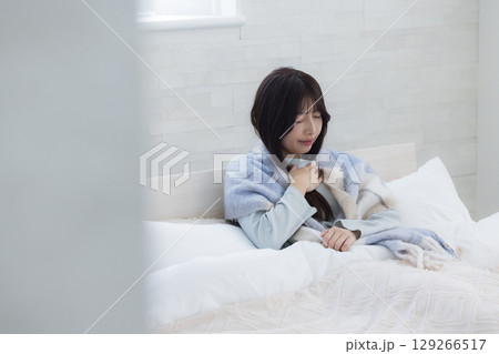 ベッドで疲れた表情の女性 129266517