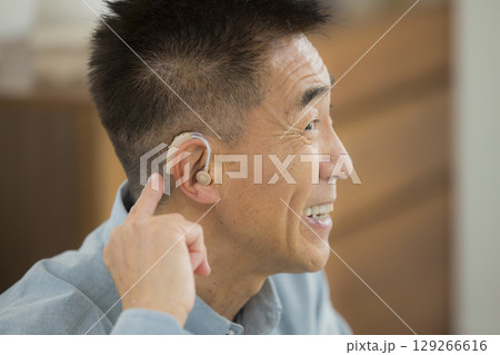 補聴器をつけたシニア男性 129266616