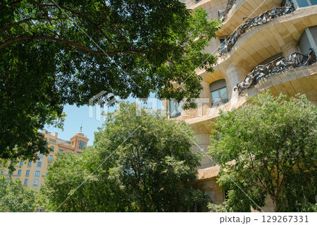 Gaudi Casa Mila Facade Architecture with Tree in Barcelona, Spain Gaudi Casa Mila Facade Architecture with Tree in Barcelona, Spain 129267331