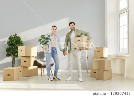 Happy moving day, young family entering new flat, celebrating relocation to own home 129267432