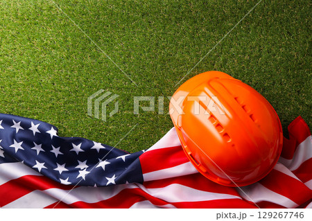 Hard hat placed on the American flag to honor workers 129267746