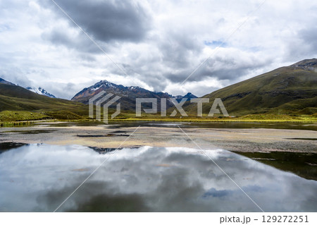 Marshy lake with snowy mountains on the Pastoruri Glacier trek, Huaraz, Peru 129272251