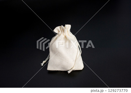 Small canvas drawstring bag on black background Small canvas drawstring bag on black background 129273770