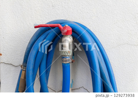 Blue Rubber Boots for Sale Beside House in the Evening 129273938