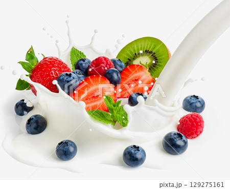Fresh mixed berries splash into milk vibrant strawberries, raspberries, blueberries, and blackberries with mint leaves isolated on white background 129275161