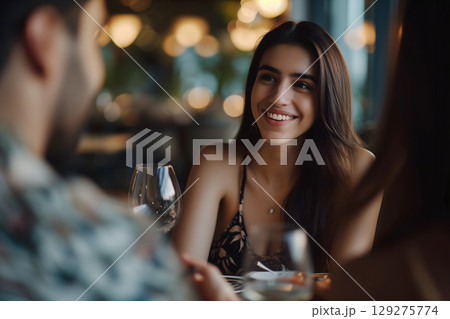 smiling young adult woman dating with young adult man at the restaurant smiling young adult woman dating with young adult man at the restaurant 129275774