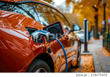 Charging of electrical vehicle, close up view, copy space Charging of electrical vehicle, close up view, copy space 129275870