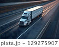 American long-nose semitruck on a highway 129275907