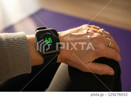 Smartwatch Displaying Heart Rate on Senior Womans Wrist 129276032