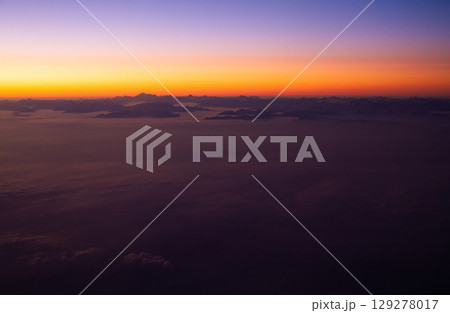 beautiful thick clouds in the sky from the height of the flight of the airplane with a view of the sunset beautiful thick clouds in the sky from the height of the flight of the airplane with a view of the sunset 129278017