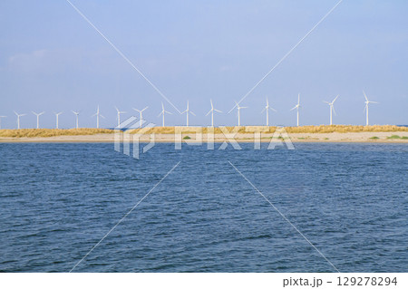 many windmills standing in the sea generate electricity many windmills standing in the sea generate electricity 129278294