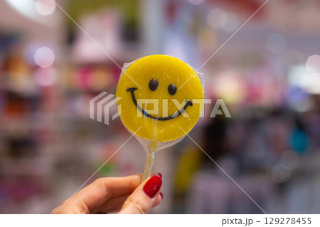 lollipop on a stick in the form of a smiley face 129278455