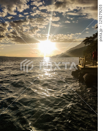 beautiful seascape on the horizon silhouette of mountains beautiful seascape on the horizon silhouette of mountains 129279203