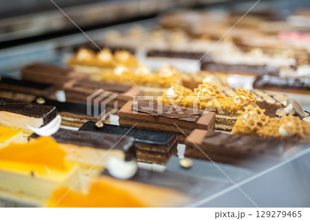 various delicious sweet pastries in the shop window. various delicious sweet pastries in the shop window. 129279465