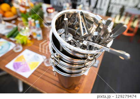 metal ice bucket on bar counter with ice scoop tool 129279474