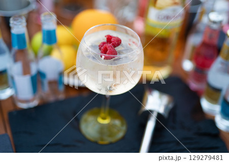 holding cool fresh alcoholic cocktail in hands at party 129279481