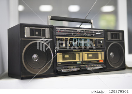 an old cassette recorder, a music center with a radio receiver an old cassette recorder, a music center with a radio receiver 129279501