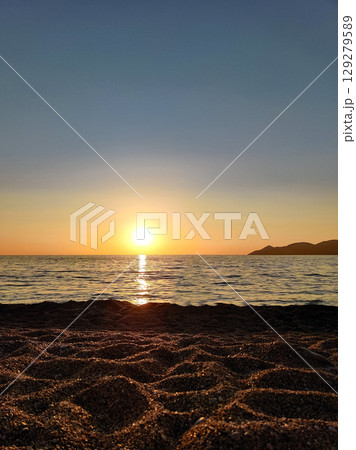 beautiful dramatic landscape of sunset on the sea beach 129279589
