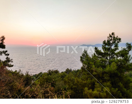 beautiful sunset on the sea with a red sun on the horizon beautiful sunset on the sea with a red sun on the horizon 129279753