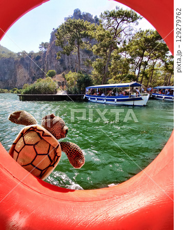 a turtle soft toy in a lifebuoy on a boat a turtle soft toy in a lifebuoy on a boat 129279762