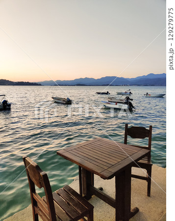 beautiful ships and boats are moored near the shore beautiful ships and boats are moored near the shore 129279775