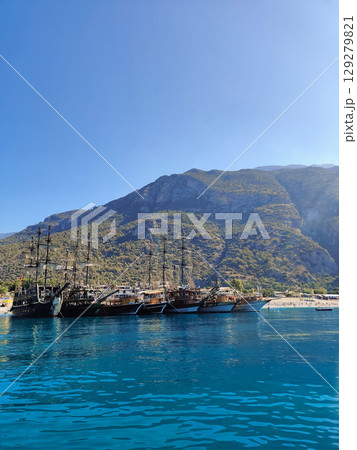 beautiful ships and boats are moored near the shore 129279821