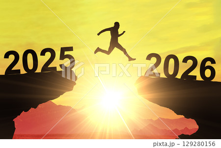Man jumping from year 2025 to 2026, a concept of new beginnings, future success, and positive business change 129280156