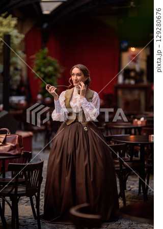 beautiful woman scientist in retro style with smoking pipe 129280676