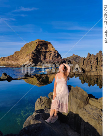 beautiful girl on rocky mountains by the sea on the island of Madeira in Portugal beautiful girl on rocky mountains by the sea on the island of Madeira in Portugal 129280743