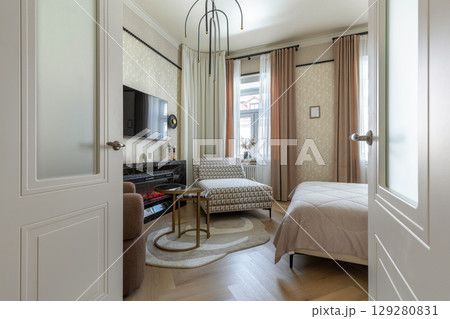 Modern Bedroom with Fireplace and TV Area 129280831