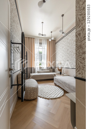 Cozy Guest Room with Beige Daybeds and Soft Lighting Cozy Guest Room with Beige Daybeds and Soft Lighting 129280883